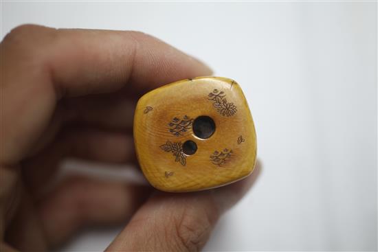 A Japanese ivory netsuke carved with nine Noh masks and another of a seated man asleep, both signed (2)